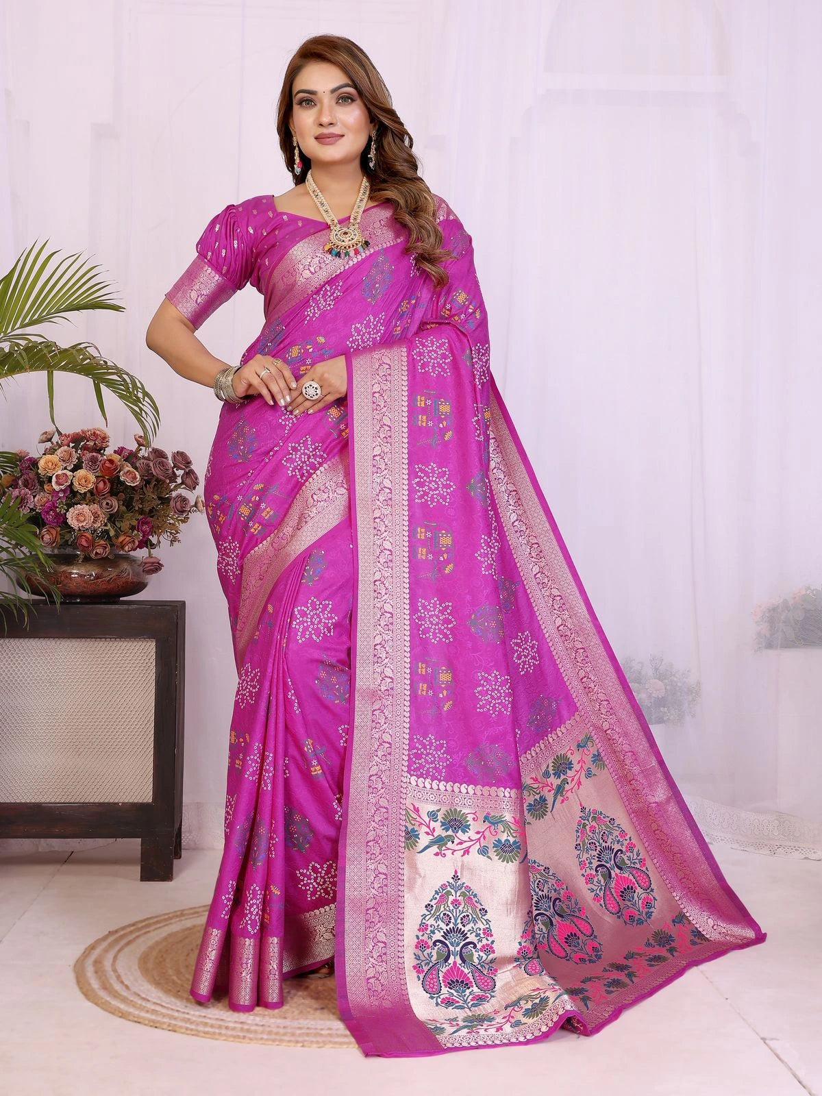 Woman wearing a pink saree with a white background