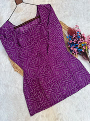 Purple patterned fabric on a hanger with flowers on a white background