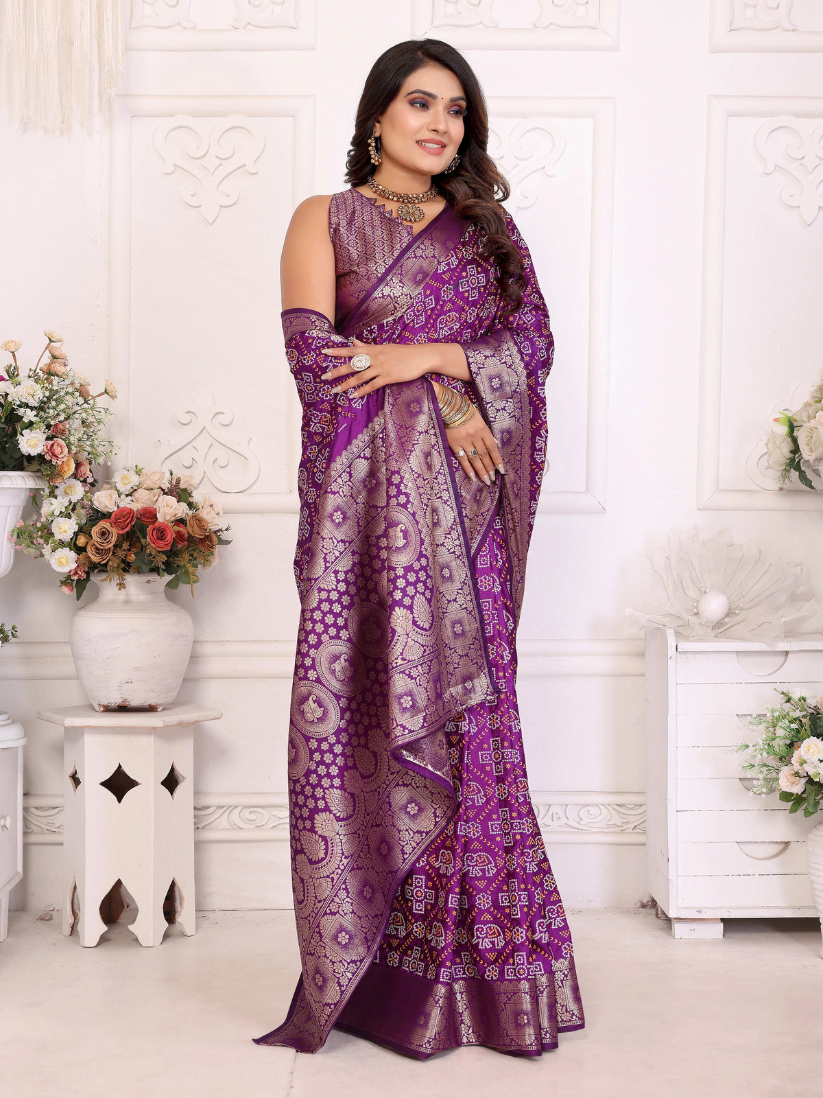 Woman wearing a purple saree with a white background