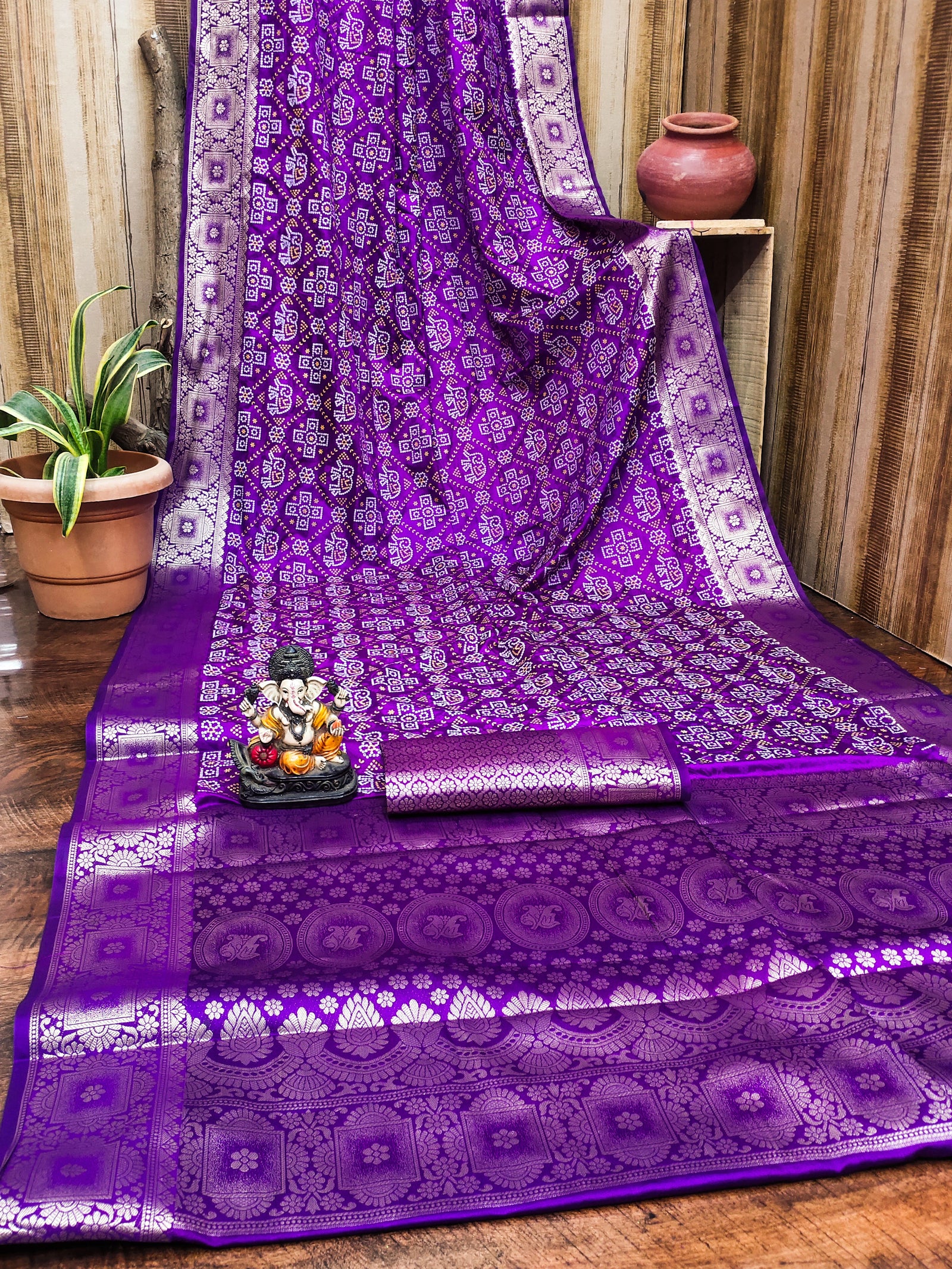 Purple saree with white patterns on a wooden floor