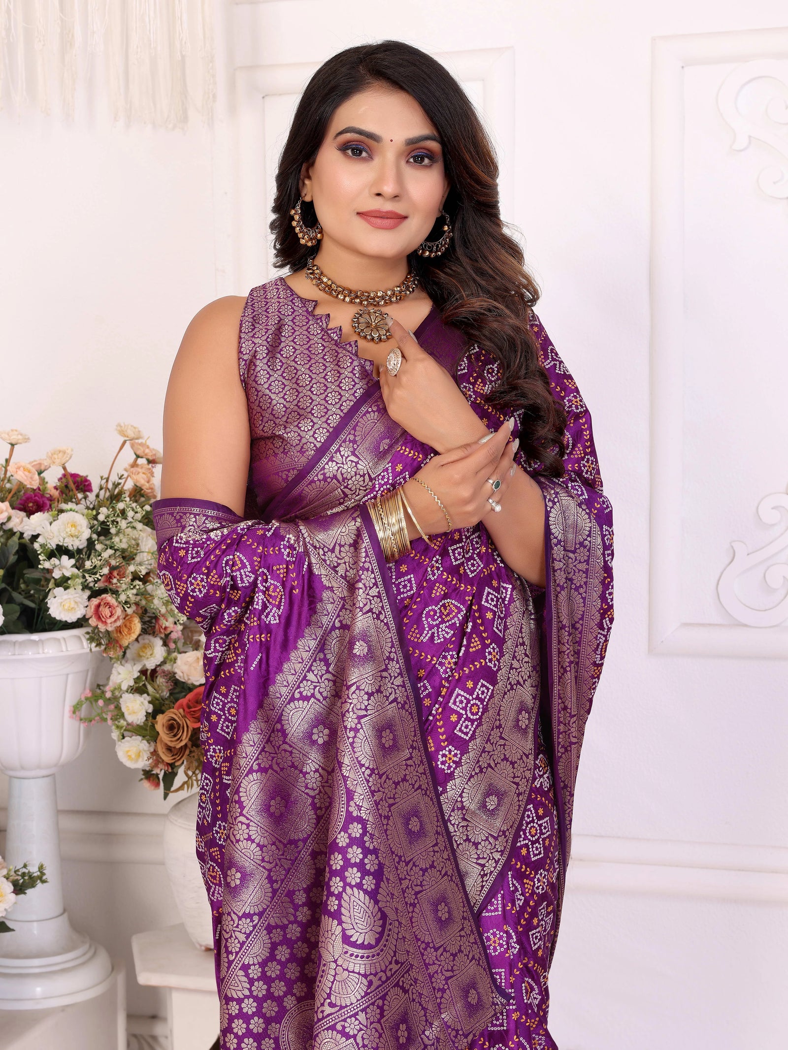 Woman wearing a purple saree with a white background