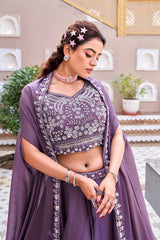 Woman in a traditional outfit with intricate patterns outdoors.