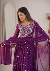 Woman wearing a purple traditional outfit with intricate designs