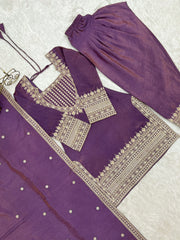 Purple traditional outfit with intricate silver embroidery on a white background