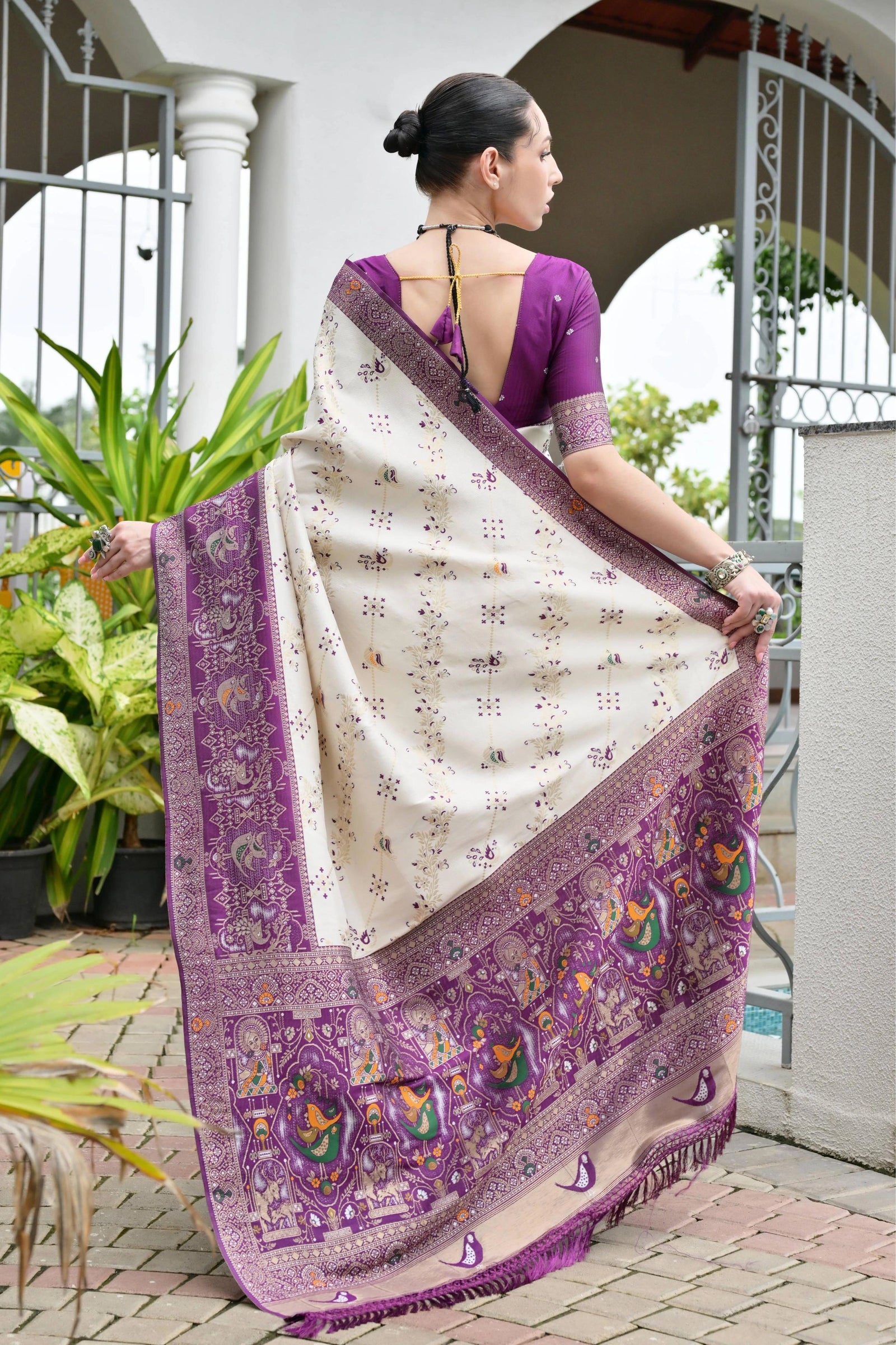 Close-up of deep purple silk saree highlighting delicate golden zari craftsmanship