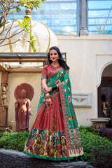 Stylish maroon Kalamkari printed saree with vibrant green border, cultural motifs, and graceful traditional design.