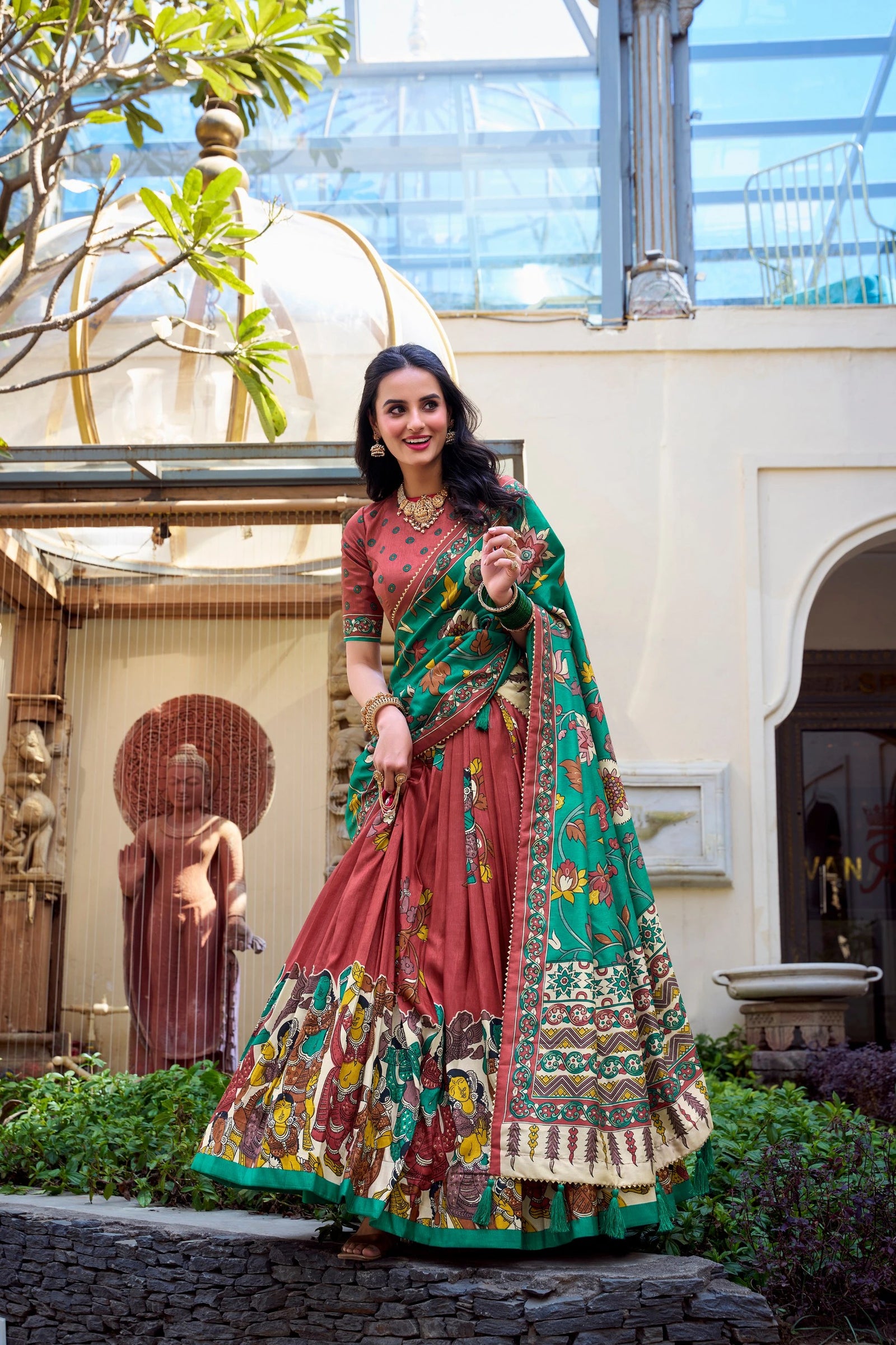 Premium maroon ethnic saree with handcrafted Kalamkari artwork, green floral pallu, and festive elegance.