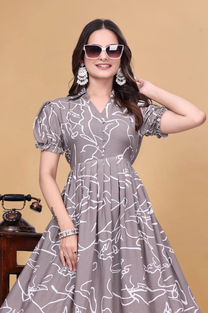 Woman wearing a gray dress with white patterns against a beige background