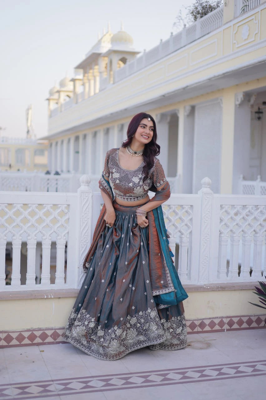 Woman in traditional outfit standing in front of a white building with architectural details