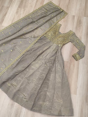 Gray saree with gold embroidery on a wooden floor