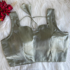 Silver metallic top on a white fur surface with red flowers.