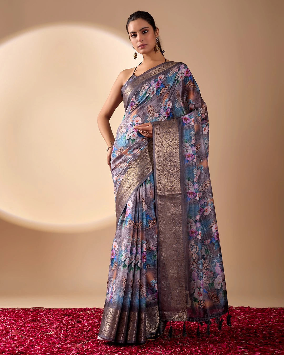 Woman wearing a floral saree with a plain background