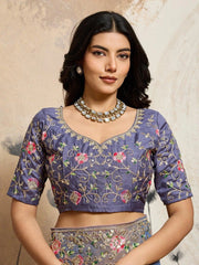 Woman wearing a traditional embroidered blouse with a neutral background