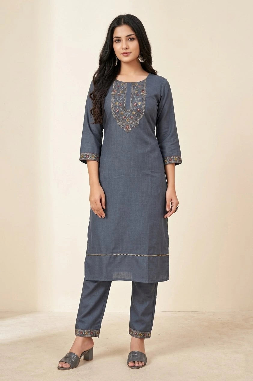 Woman wearing a blue kurta with embroidery on a beige background