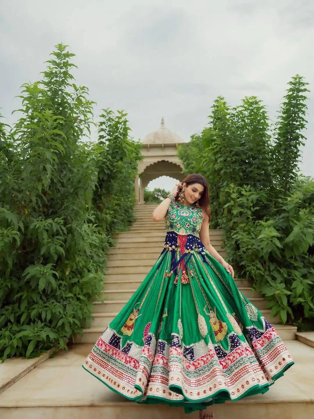 Green Digital Print Lehenga front view on garden path near pavilion