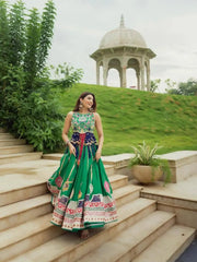 Green Digital Print Lehenga walking down garden steps near domed pavilion