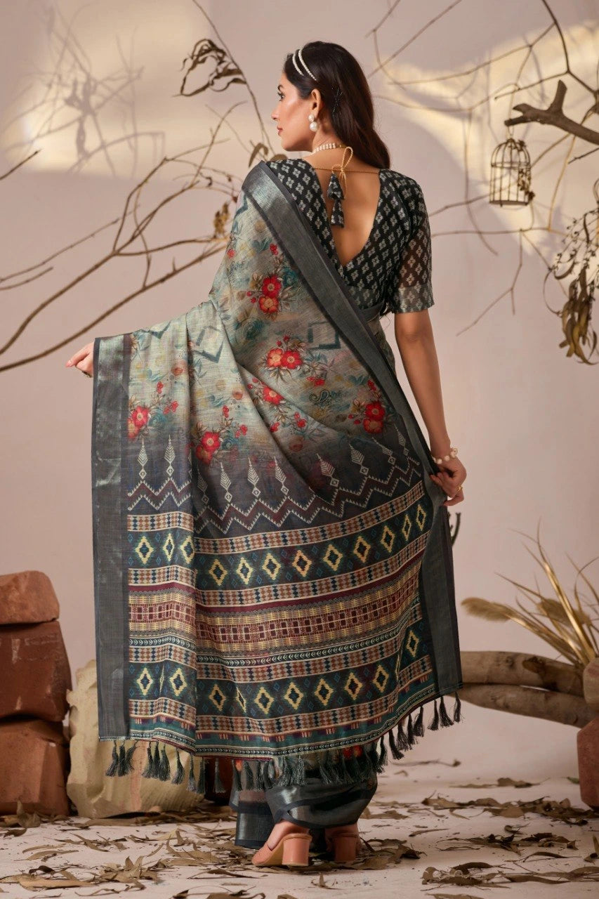 Woman wearing a patterned saree with a neutral background