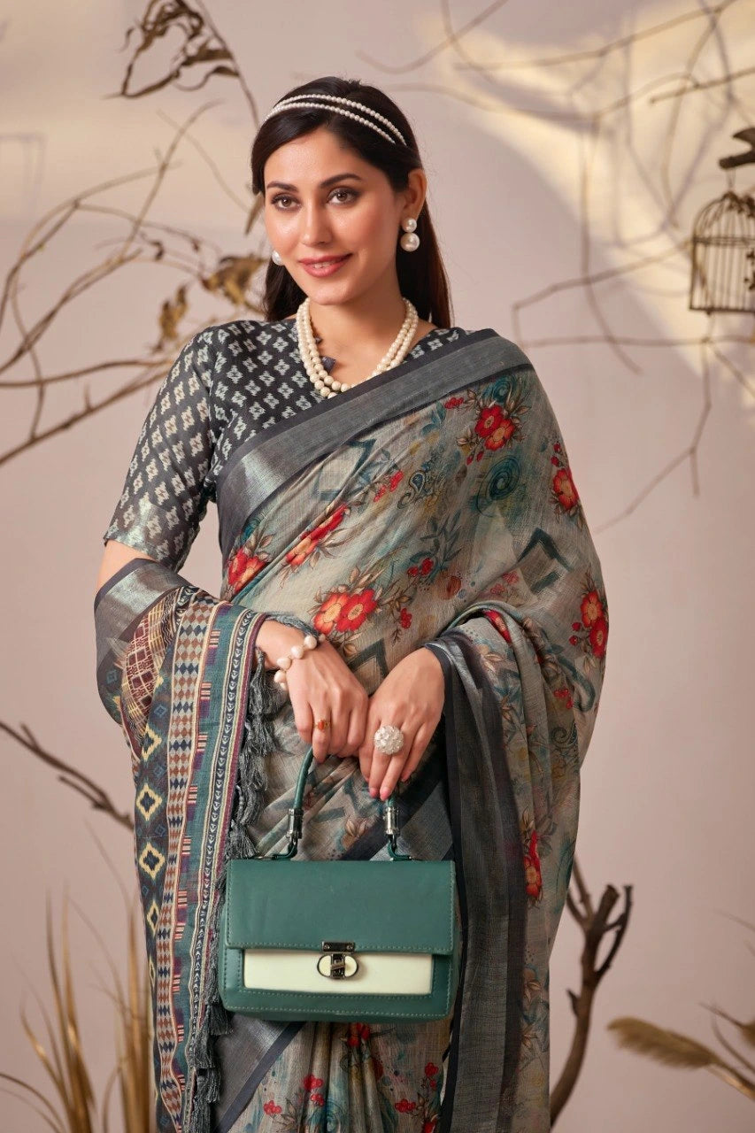Woman wearing a floral saree with a green handbag against a neutral background