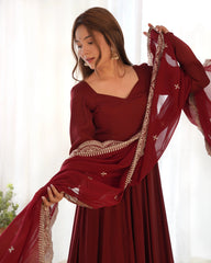 Woman wearing a red traditional outfit with a matching dupatta, holding it up.