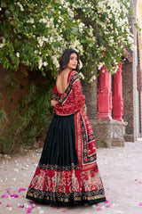 Black Floral Print Lehenga back view – open back choli, patola elephant border skirt with gold zari hem, foil work detail