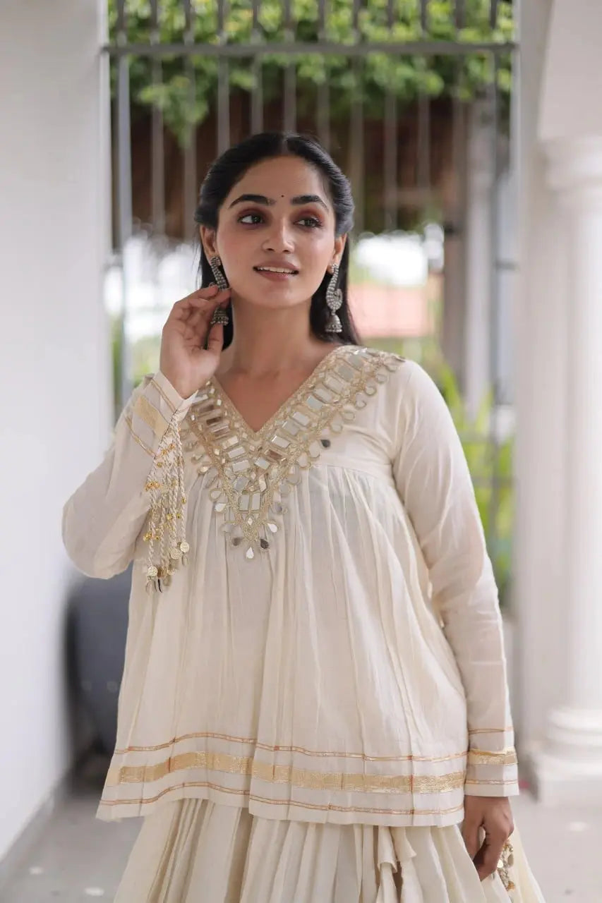 White Zari Work Lehenga – V-neckline close-up showing dense shisha mirror embroidery with gota patti outlining on white base