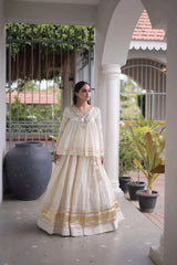 White Zari Work Lehenga – Side view showing 3.5-meter circular flair and full sleeve peplum top with kodi tassel cuffs