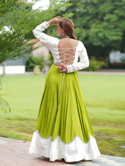 Green Mirror Lace Work Lehenga – Choli close-up showing mirror-sequin trim, chevron peplum overlay with cowrie shell fringe