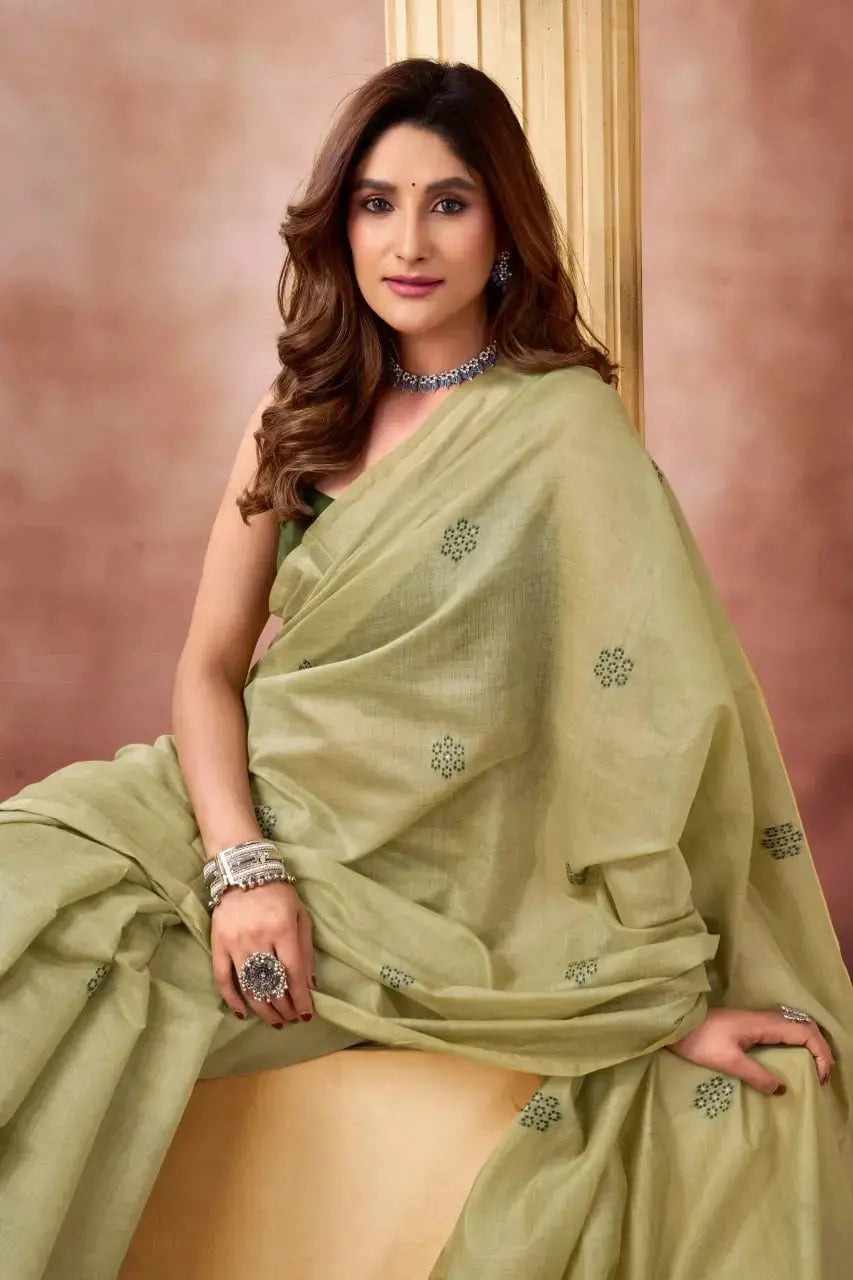 Light Pistachio Green Jacquard Weaving Saree — seated pose highlighting scattered buti pattern on fabric