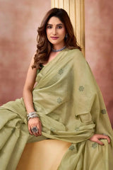 Light Pistachio Green Jacquard Weaving Saree — seated pose highlighting scattered buti pattern on fabric