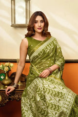 Seated half body view of Android Green Jacquard Weaving Saree — blouse and woven ikat design detail