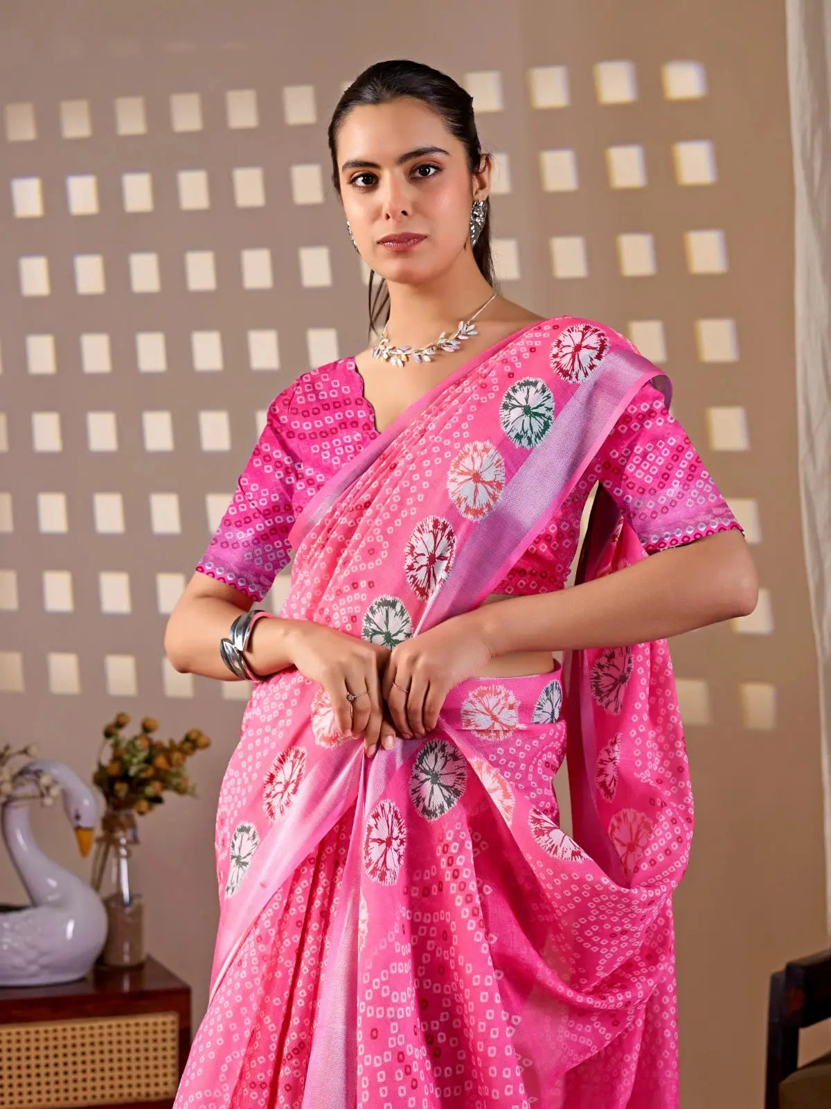 Half body view of Pink Floral Digital Print Saree — holding pallu showing multicolour shibori medallions