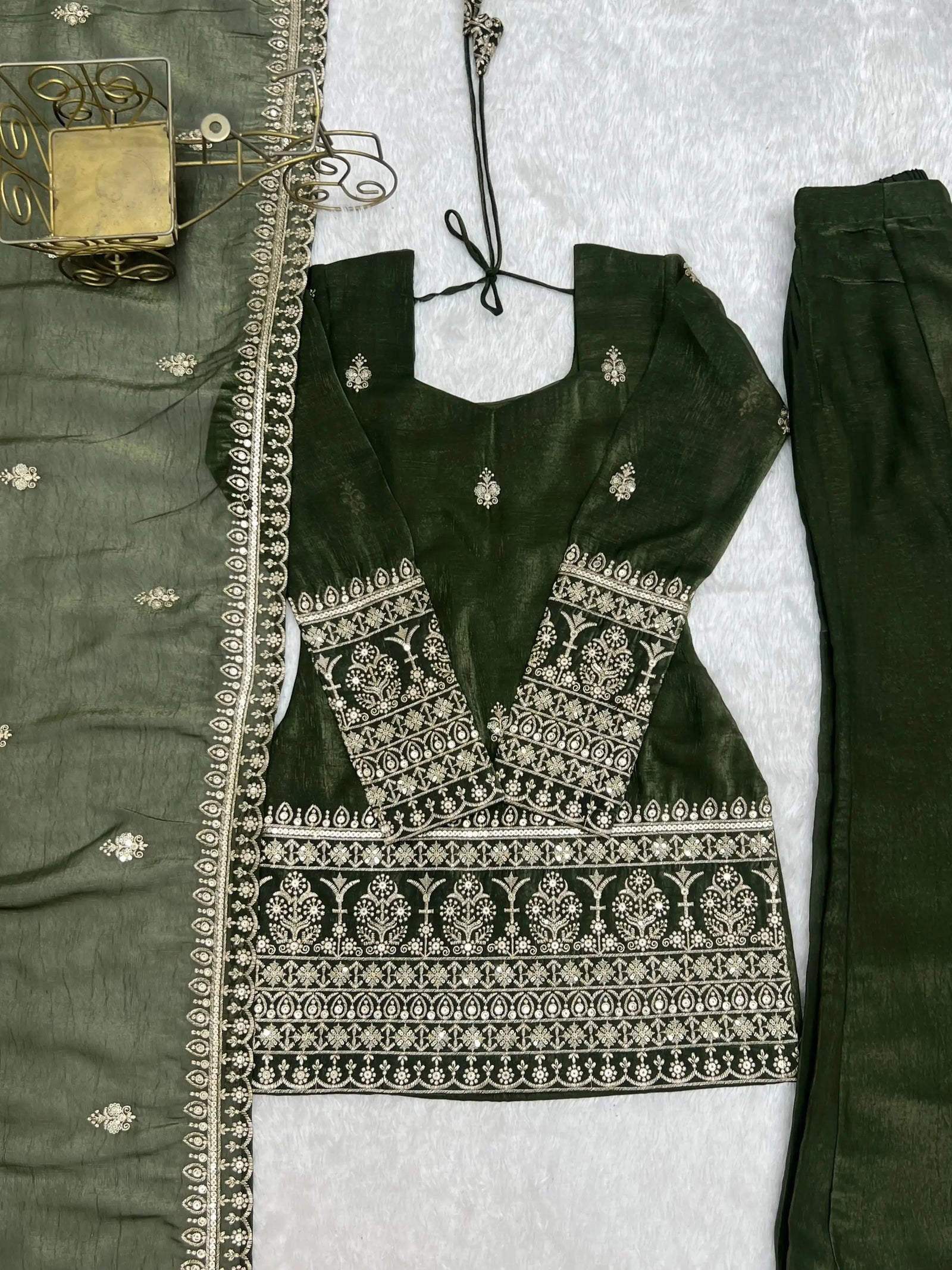 Flat lay close-up of heavy sequin and zari embroidery bands on Olive Green Suit hem