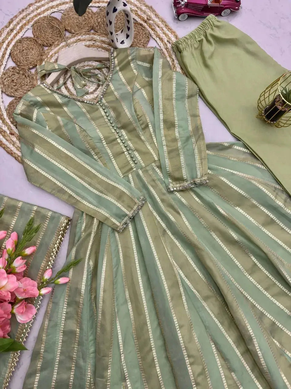 Close-up flat lay of gold striped jacquard fabric and straight pants