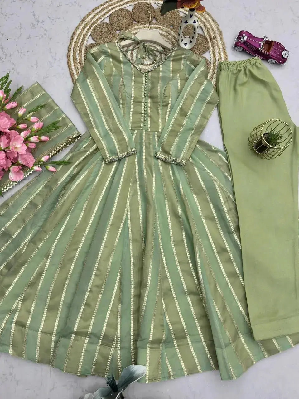 Soft pastel green mirror work suit set flat lay with dupatta and straight pants