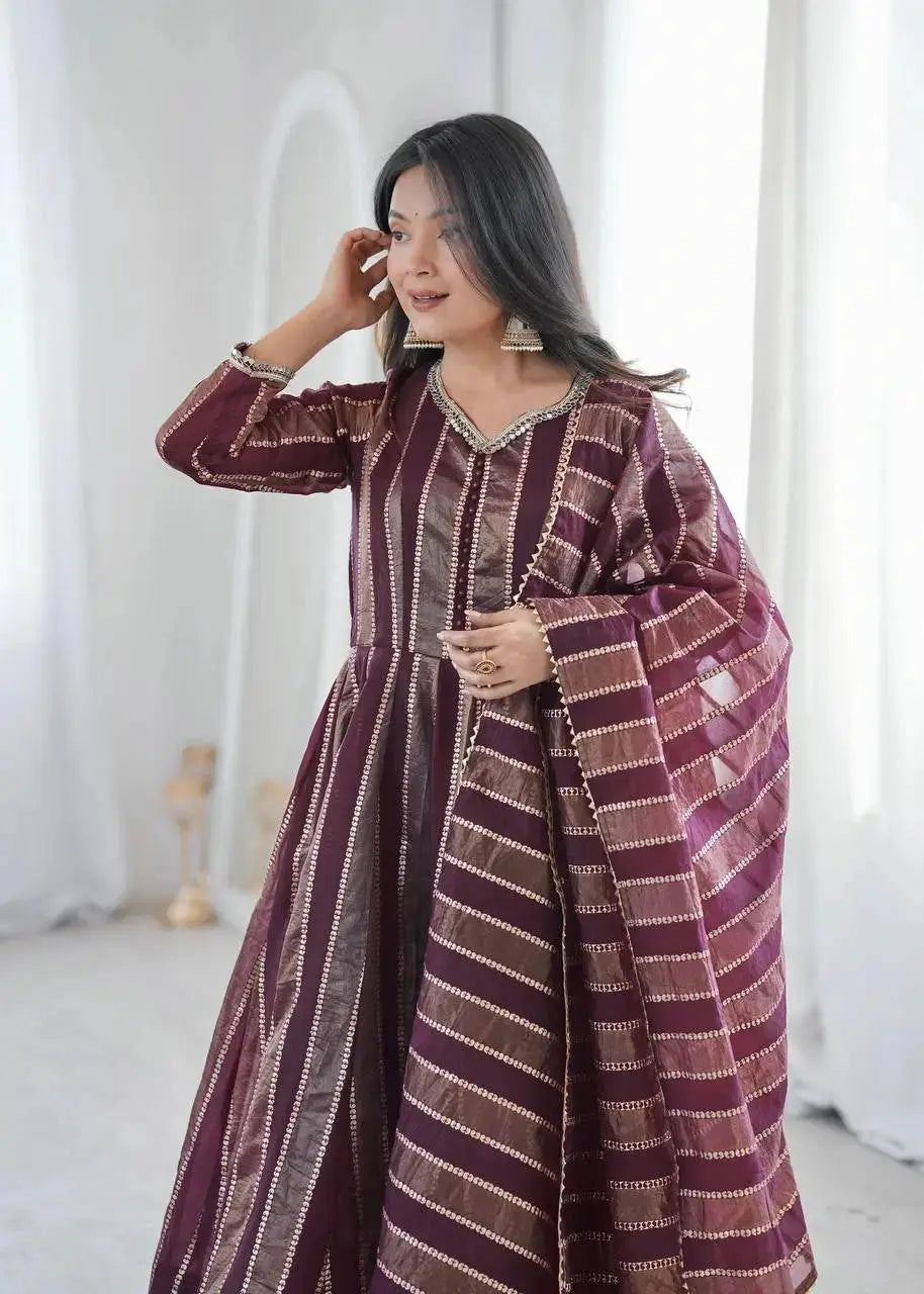 Close-up portrait of mirror work neckline and cuff on wine anarkali suit