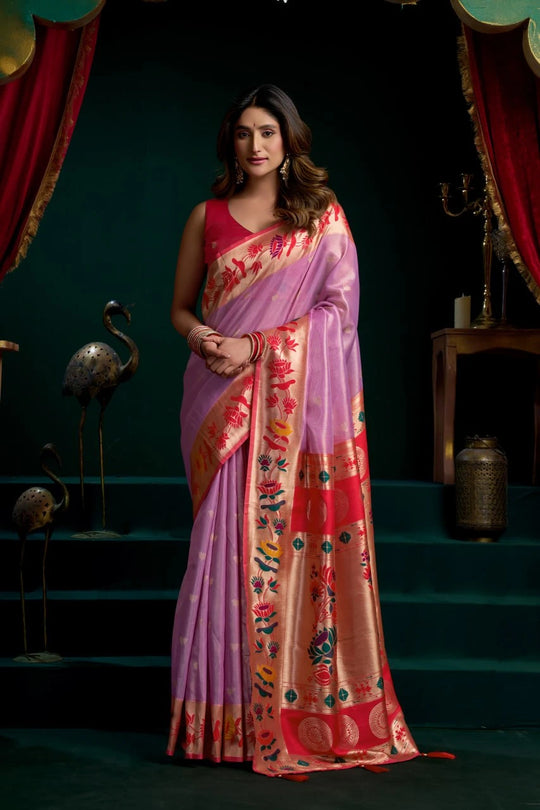 Woman wearing a colorful saree with a dark background