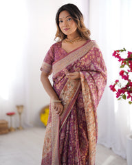 Woman wearing a pink and purple saree with a white background