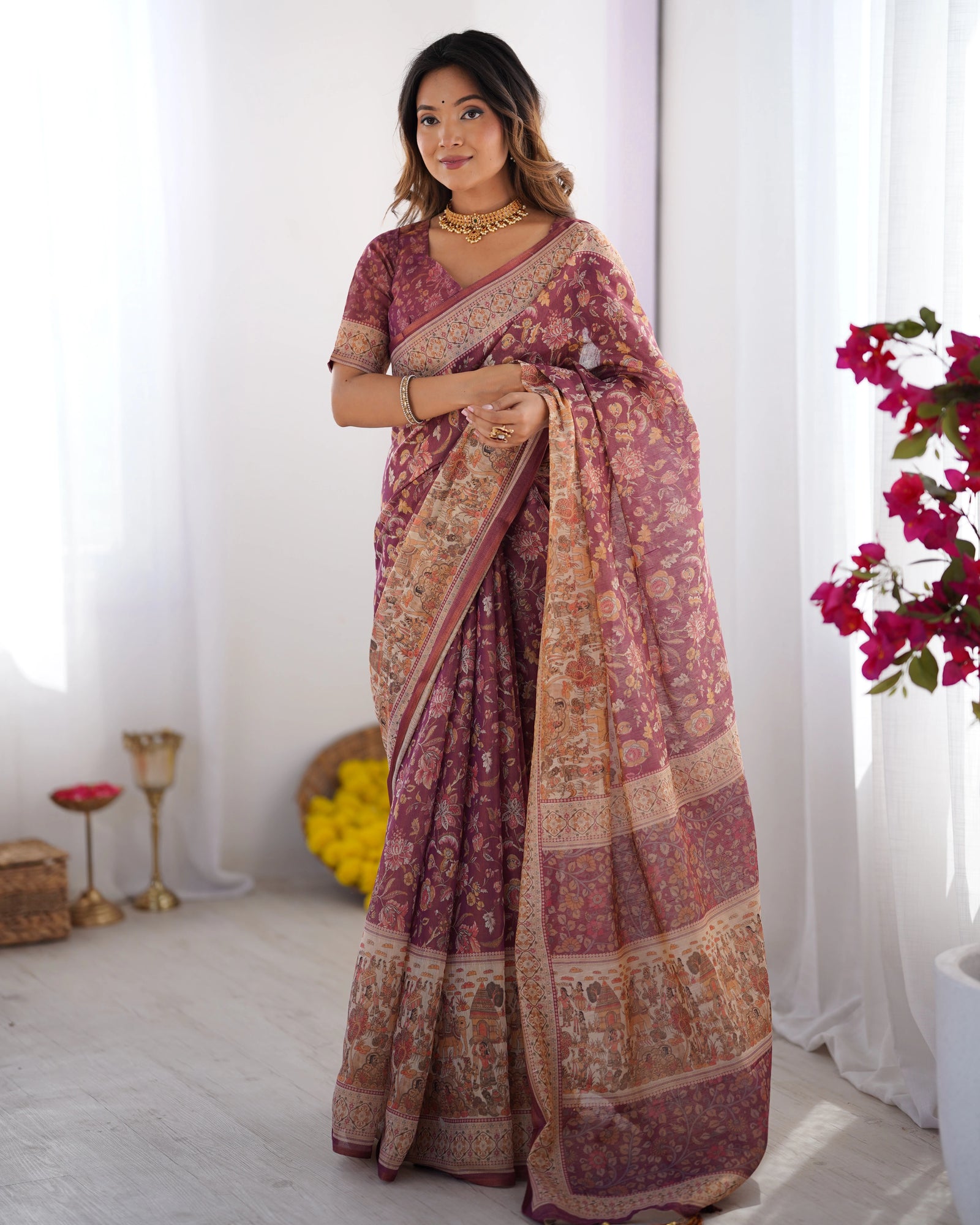 Woman wearing a traditional saree with a floral background