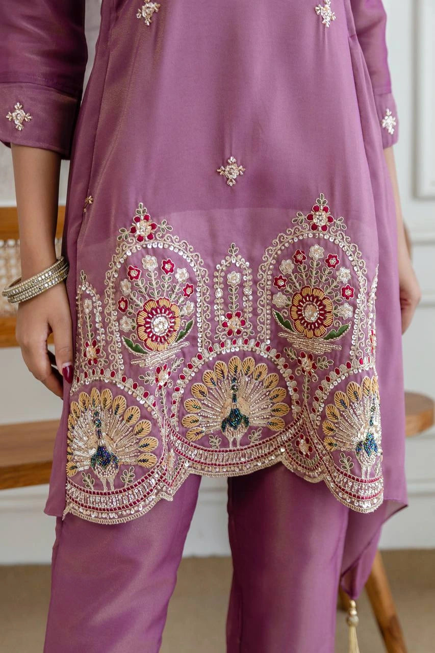 Purple embroidered outfit with intricate designs on a blurred background