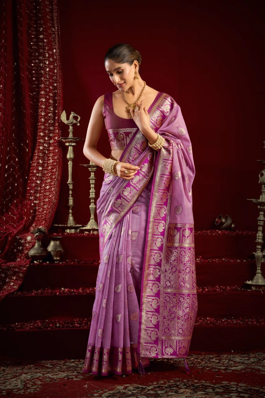 Woman in a traditional purple saree with a red background