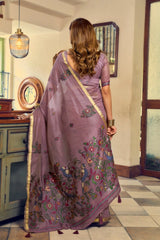 Woman wearing a traditional saree in a room with decorative elements.
