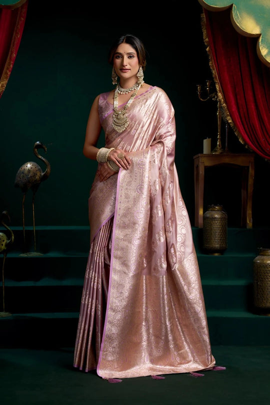 Woman in a pink saree with a dark background