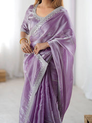 Purple saree with silver border worn by a person on a white background