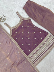 Purple traditional outfit with gold embroidery on a light gray background