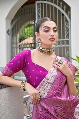 Luxurious lavender pink soft silk saree folded neatly, showcasing fine zari weaving details.