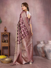 Woman wearing a traditional saree with a patterned design, standing against a neutral background.