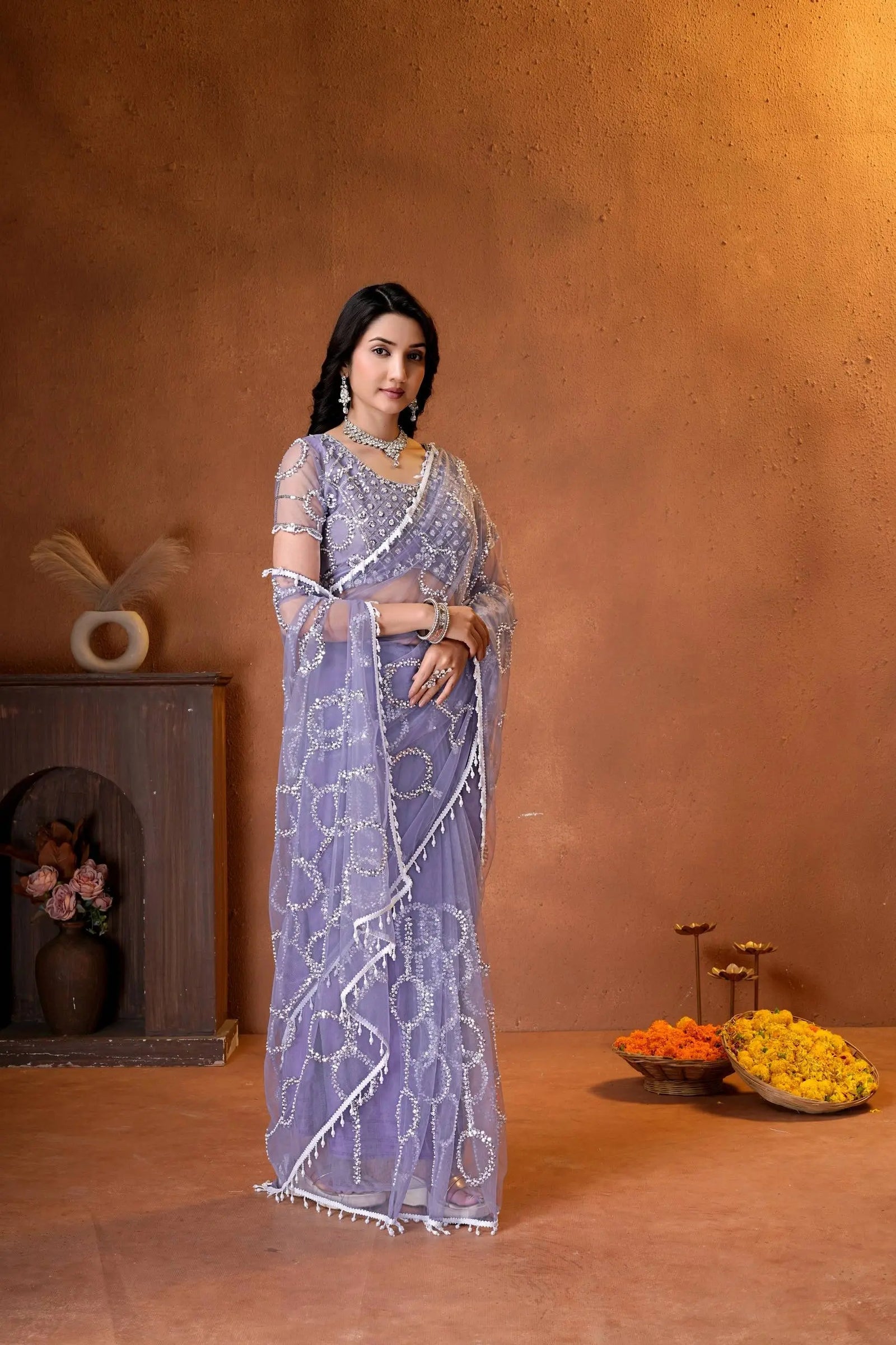 Premium party wear saree with a matching embroidered blouse, delicate beadwork, and a beautifully flowing sheer drape.