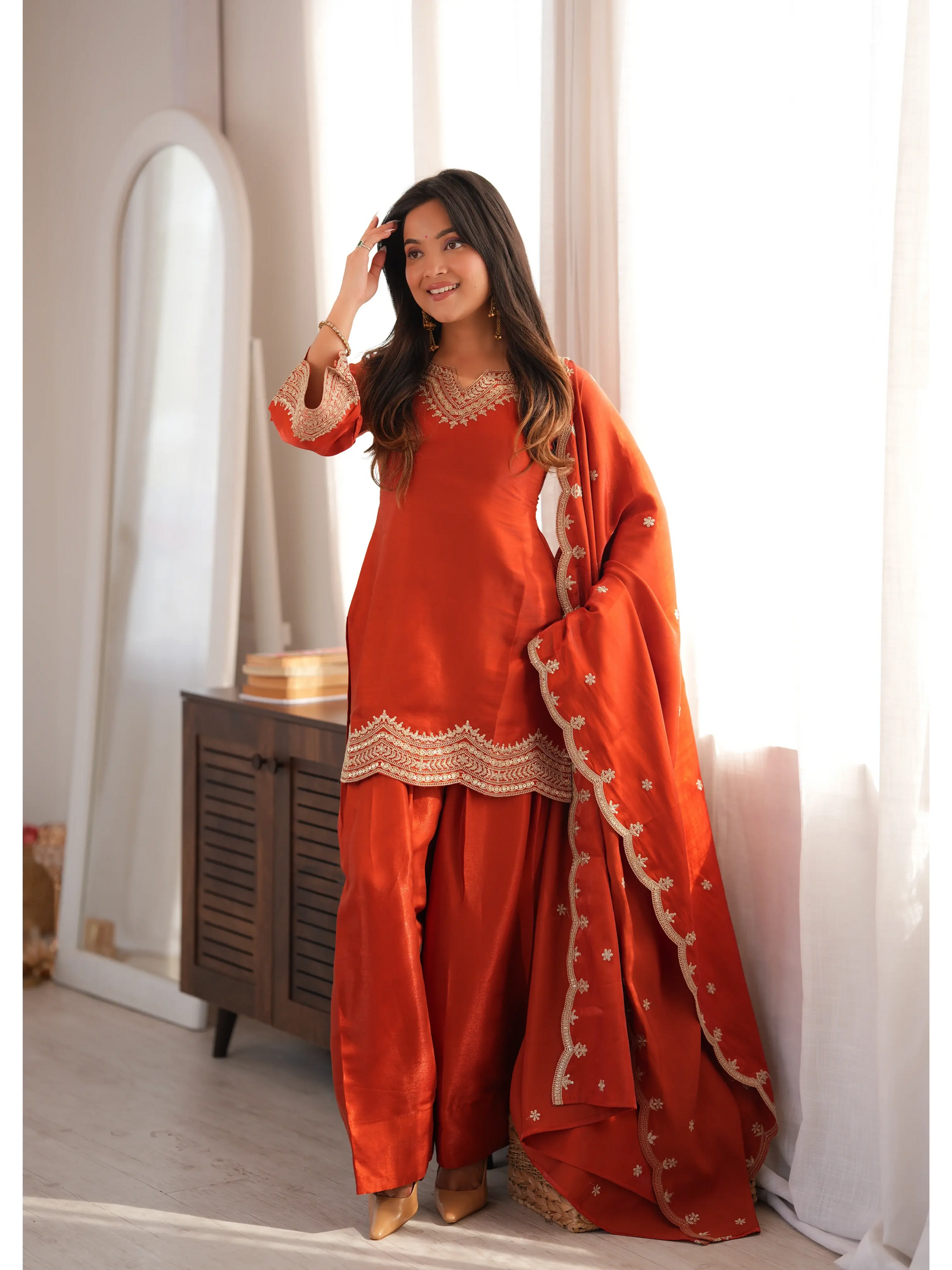 Light Orange Sequins Suit with dupatta draped over shoulder