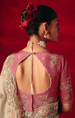 Woman wearing a pink embroidered blouse with a red background