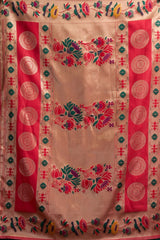 Decorative fabric with intricate patterns and colors on a beige background